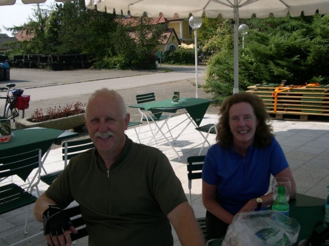 Craig and Yvonne Thomson taking a beer break while cycling by the Danube in Austria September 2008